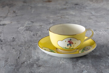 Yellow Cup and Saucer with Hand Painted Oriental Figures T.Goode Commission England 1900s