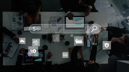 A top-down view of a business team engaged in a collaborative meeting, analyzing data on digital tablets and discussing strategies with various icons displayed. Raster - Powered by Adobe