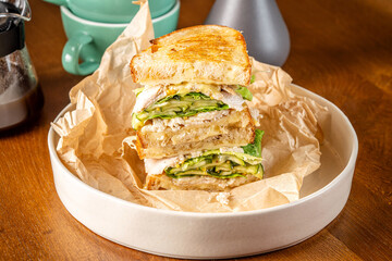 Grilled chicken sandwich with cheese, cucumber, and lettuce