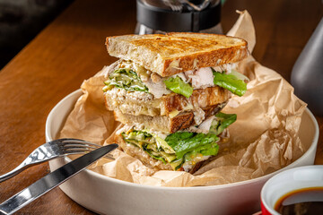 Grilled chicken and lettuce sandwich with melted cheese