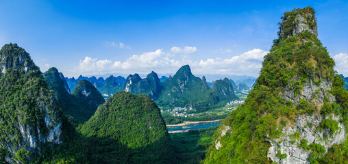 Aerial shot of the spectacular karst mountain with lush green forest landscape in Guilin, China.