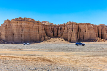 Desert road and spectacular yardang landform mountain natural landscape in Xinjiang, China.