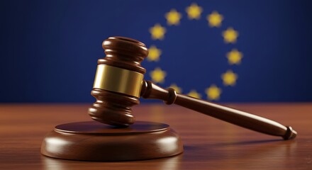 Wooden gavel and block resting on a desk, symbolizing law and justice in the context of the European Union flag