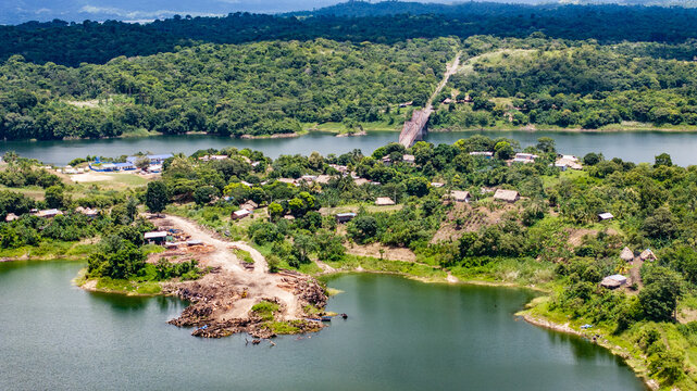 Aerial landscape view of area around Akua Yala in Babita de Perro, Panama, with "Carretera Interamericana" highway and "Puente Sobre El Bayano" bridge across Bayano Lake and  houses between vegetation