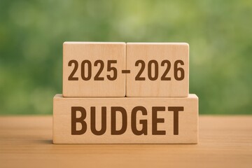 Wooden Blocks Displaying Yearly Budget Plan for 2025 to 2026 on Natural Background
