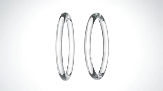Interlocking clear glass rings create a symbol of unity and connection on white