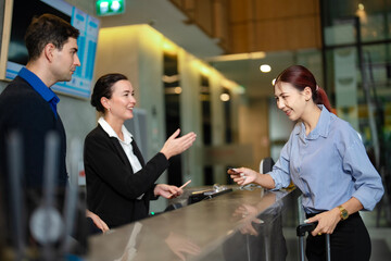 Professional hotel staffs supporting guest during check-in and payment process, symbolizing hospitality, international tourism, and seamless service for global travelers.
