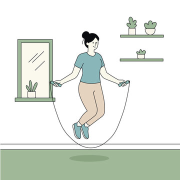 A woman jumps rope inside her home near the window, keeping active with an easy indoor workout.
