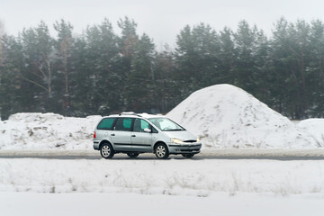 Car driving through frosty winter road