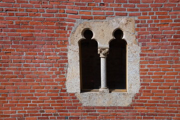 Stone window on the brick wall