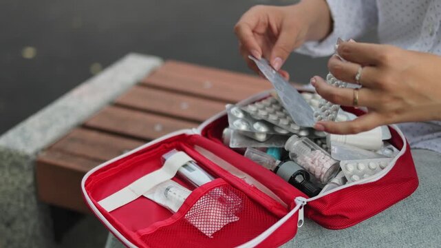 First aid kit. Woman in the park. Slow motion. High quality 4K video.