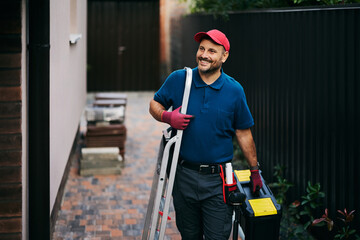 Happy handyman coming to customer's house. © Drazen