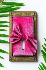 Pink velvet bow on aged metal plate, with green leaves