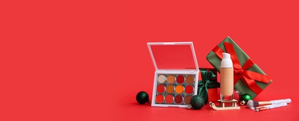 Christmas decorations and cosmetics on red background with space for text