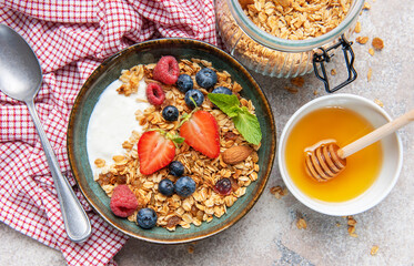 Granola yogurt parfait with fresh berries and honey