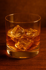 Glass of Whiskey on Wooden Table with Warm Light