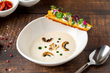 Creamy mushroom soup garnished with sautéed mushrooms and crisp