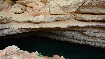 A footage of the Bimmah Sinkhole, a natural wonder located in Hawiyat Najm Park, Oman. This water filled depression in the limestone is known for its stunning turquoise waters and is a popular tourist