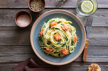 Pasta spaghetti with salmon, spinach, and cheese. Italian cuisine. Healthy eating.