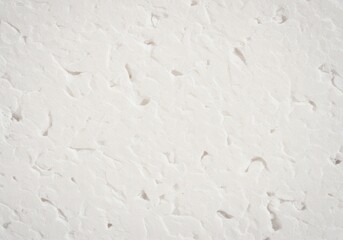 Obraz premium Subtle textured white plaster background with natural organic undulations and soft shadows, perfect for clean modern design and minimalist backdrops.