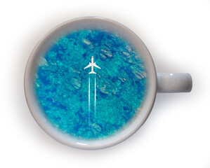 Take a travel like a cup of coffee! Travel concept of flying air plane above blue turquoise summer sea in a cup of coffee, season of tourism and journey concept