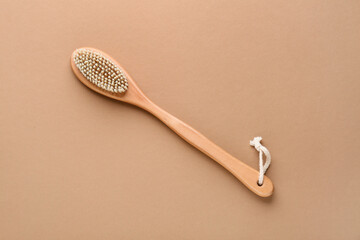 Massage body brush on brown background, closeup