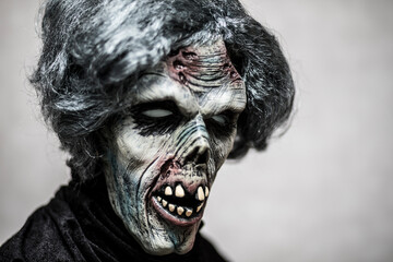 Portrait of a scary zombie with gray hair
