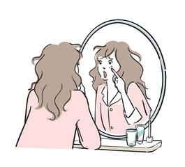 鏡を見て肌荒れに気がつくパジャマ姿の女性