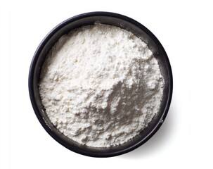 Fluffy white flour fills a dark bowl