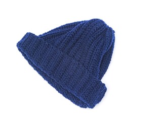 A top-down, isolated shot of a thick, navy blue knitted beanie hat with a ribbed cuff, folded and resting on a white background. A warm and casual winter fashion accessory.