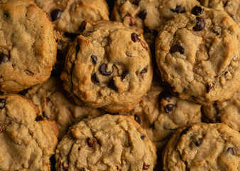 Close up of freshly baked chocolate chop cookies filling frame.