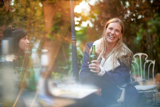 happy woman at garden party with a drink