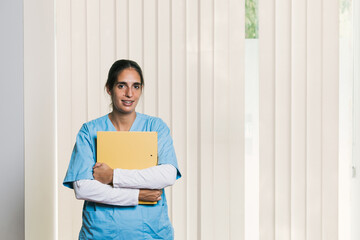 Young physiotherapist holding medical records in rehabilitation center