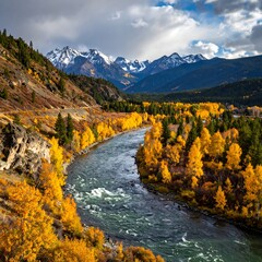 Scenic view of a river winding through autumn foliage, mountains behind