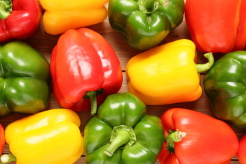 Texture of fresh colorful bell peppers on wooden background