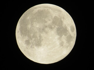 A detailed close-up of the radiant full moon against a dark, starless night sky, captured in the early hours of August 30, 2015, highlighting its craters and textures.