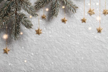 Christmas border with pine branches, white and gold confetti stars on a gray textured concrete background. Xmas frame, Happy New Year template. Deluxe holiday wishes concept. Space for festive words