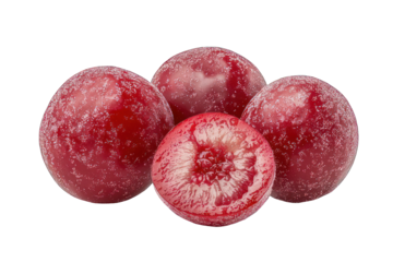 Four plums, one halved to reveal interior flesh, on black backdrop