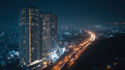 Obraz premium Nighttime cityscape with illuminated skyscrapers and busy highway lights