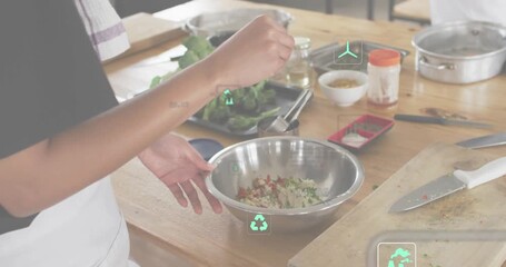 Home cook picking pinch seasoning and stirring bowl while green tech icons appearing showing impact - Powered by Adobe