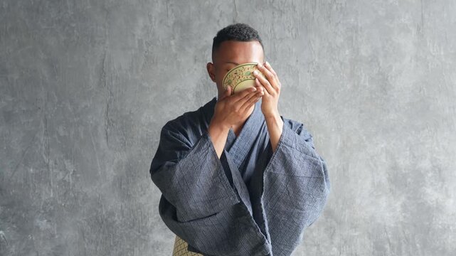 A black man wearing a yukata and experiencing a tea ceremony