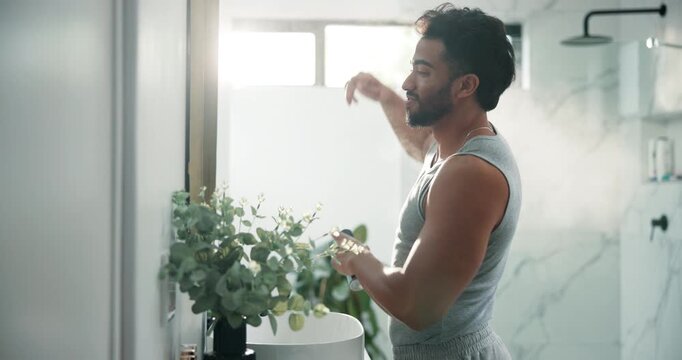 Man, mirror and spray deodorant in bathroom for hygiene, smell fresh and grooming for odor control. Male person, armpit and product with clean fragrance, body cosmetics and sweat prevention at house