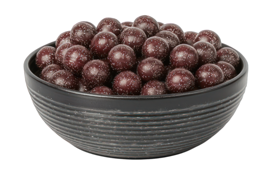 Round dark chocolate balls speckled with white in textured black bowl