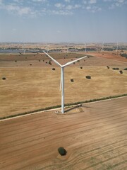Rotating wind turbine in wind turbine park located in open rural landscape