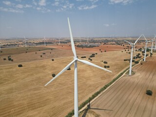 Wind turbine park in open rural landscape with multiple rotating windmills