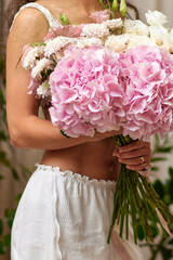 female hands holding bouquet flowers. Gift on the 8 march or valentines day. pink hydrangea