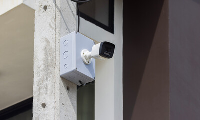 CCTV camera on the lamp post during the day.
