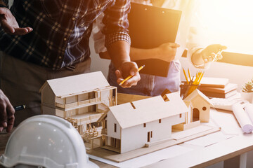 Construction engineer working at blueprint to build large commercial buildings in office. Engineering tools and construction concept.