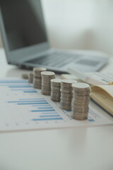 Saving money wealth concept, asian young business woman hand write management budget for saving cost, cash finance planning to spend enough money on her income for save money, payment tax, investing.