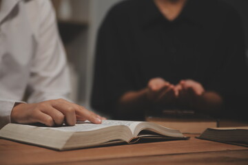 Christian group are praying to god with the bible and sharing the gospel. Concept of faith for god.